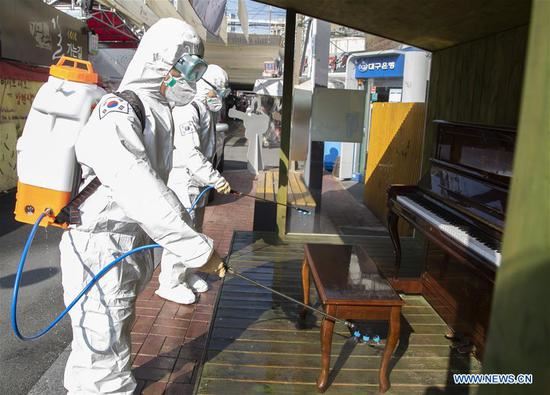 South Korean army soldiers in protective suits sterilize the Kim Kwangseok street in Daegu, South Korea, March 5, 2020. (Photo by Lee Sang-ho/Xinhua)